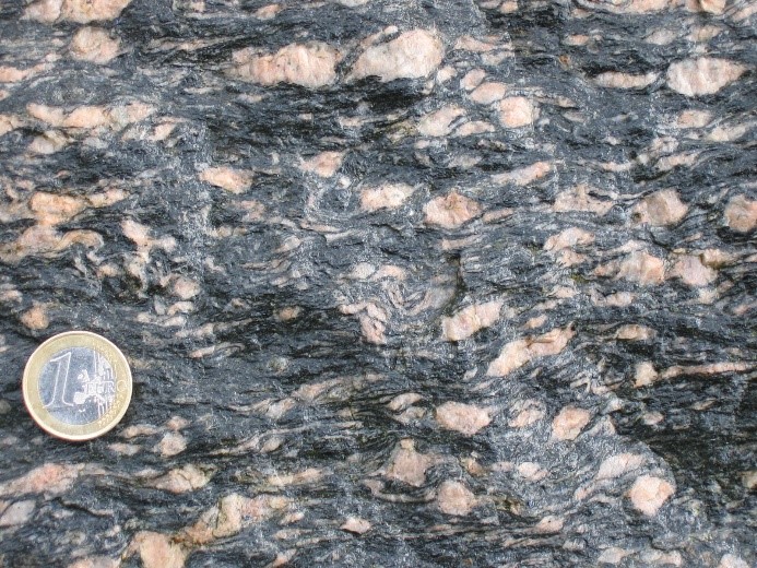Ochre gneiss with pink feldspar.
